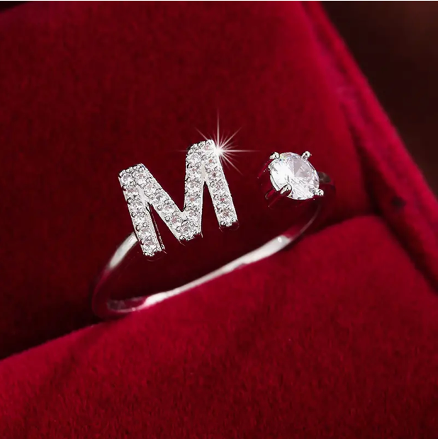 Faszinierender Buchstabenring aus Gold und Silber, besetzt mit funkelnden Diamanten