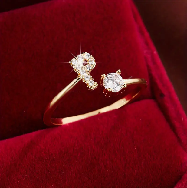 Faszinierender Buchstabenring aus Gold und Silber, besetzt mit funkelnden Diamanten